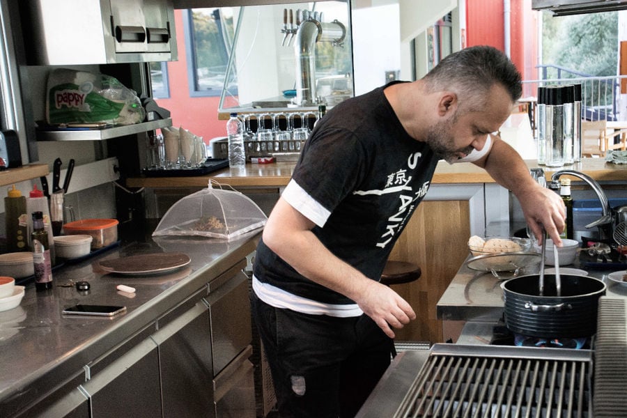 man cooking in the cuisine of Cretan Brewery
